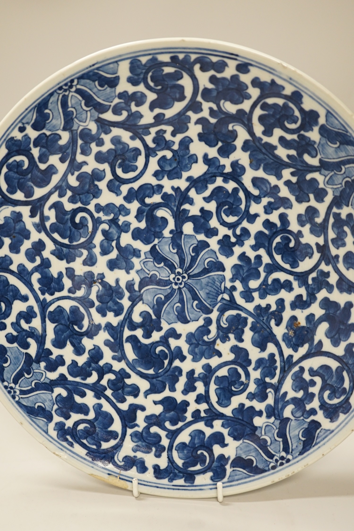A Chinese blue and white ‘lotus’ charger, together with a bowl and dragon pot on tripod base